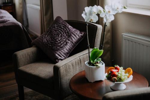 a living room with a chair and a coffee table at Willa Sepia SPA in Wisła