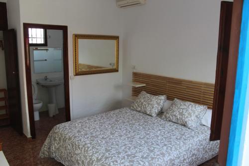 a bedroom with a bed and a mirror and a sink at Casaflor in Mojácar