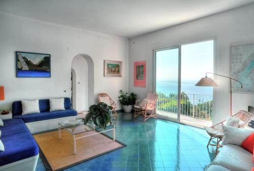 a living room with a view of the ocean at Villa in the green, extraordinary silent position, great lake view in Garda
