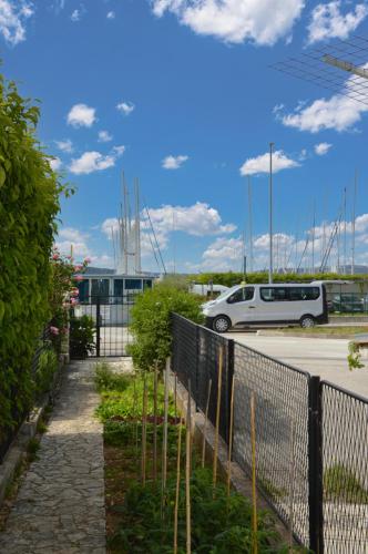 a car parked in a parking lot next to a fence at ISSA Holiday Home - 3 Min Walk to Beach in Kaštela