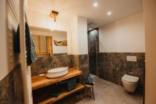 a bathroom with a sink and a toilet at Chalet Passeier - ZOLL in Saltusio