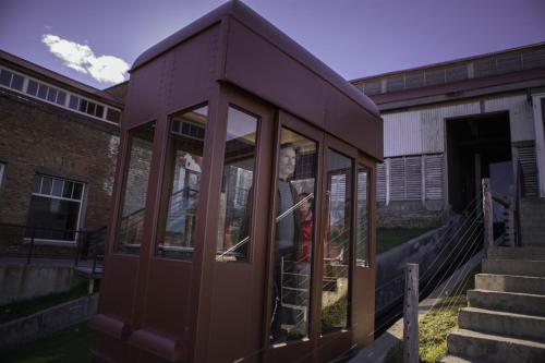 a woman is standing inside of a building at The Singular Patagonia Hotel in Puerto Natales
