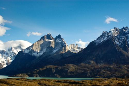 a mountain range with a lake in the foreground at The Singular Patagonia Hotel in Puerto Natales