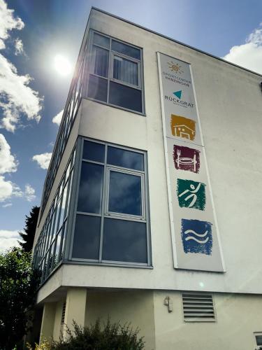 a building with signs on the side of it at Sport Hotel Kenzingen inklusive Schwimmbad, Sauna und Frühstück nähe Europa-Park in Kenzingen