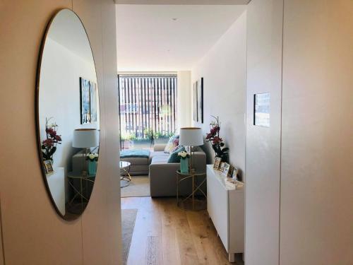 a living room with a couch and a mirror at Apartment PURO HOMES in Aveiro