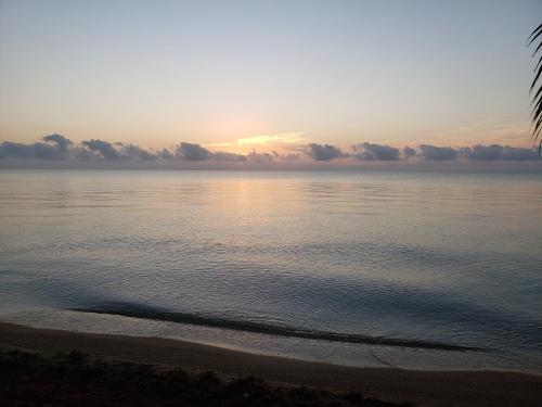 a view of the ocean with the sun setting at Pal's on the beach - Dangriga, Belize in Dangriga