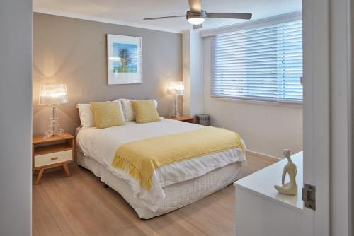 a bedroom with a bed and a ceiling fan at Inner City Harbour Views With Parking in Sydney