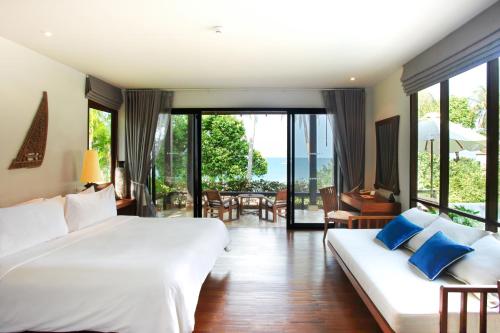 a bedroom with two beds and a view of the ocean at Pimalai Resort & Spa in Ko Lanta