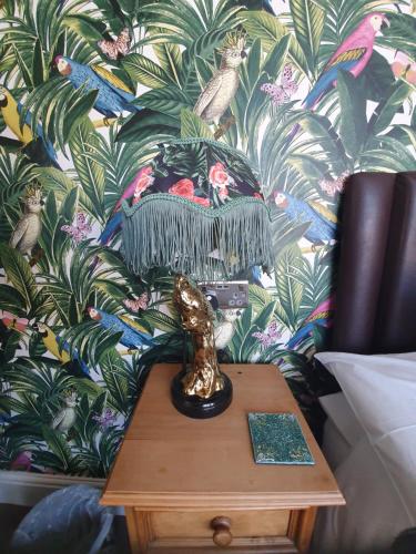 a lamp on a table in front of a wall at The Dudley Hotel in Blackpool
