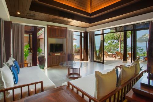 a living room with a table and chairs at Pimalai Resort & Spa in Ko Lanta