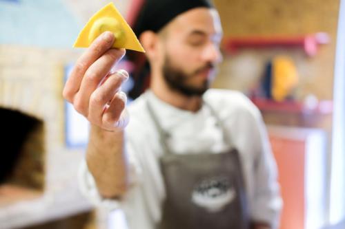 a man holding up a piece of food in his hand at Masseria Sant'Agapito in Lucera