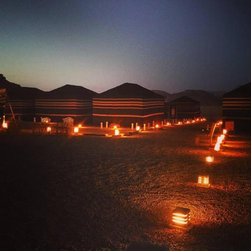 a group of lights in a desert at night at WADI RUM STAR WARS CAMP in Wadi Rum