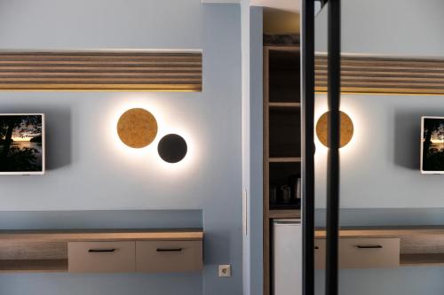 a kitchen with three planets on the wall at Country Inn in Kallithea Halkidikis