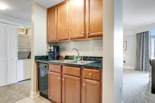 a kitchen with wooden cabinets and a sink at Anderson Ocean Club and Spa by Oceana Resorts in Myrtle Beach