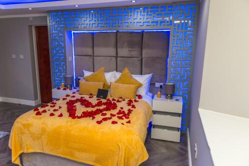 a bedroom with a bed with red roses on it at Meridian Serviced Apartments in Bradford