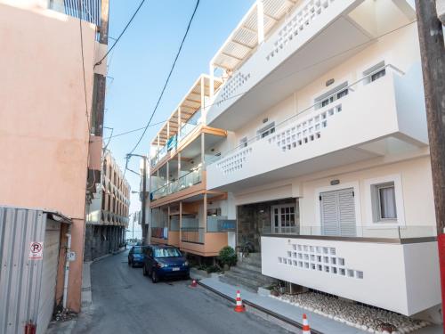 a building with balconies on the side of a street at Aristo Apts in Hersonissos