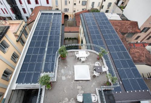 an array of solar panels on the roof of a building at Hotel Marconi in Milan