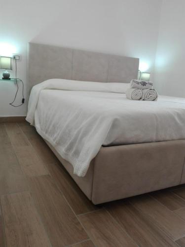 ein Schlafzimmer mit einem großen Bett mit zwei Handtüchern darauf in der Unterkunft A un passo dal mare Budoni - Matta e Peru in Tanaunella