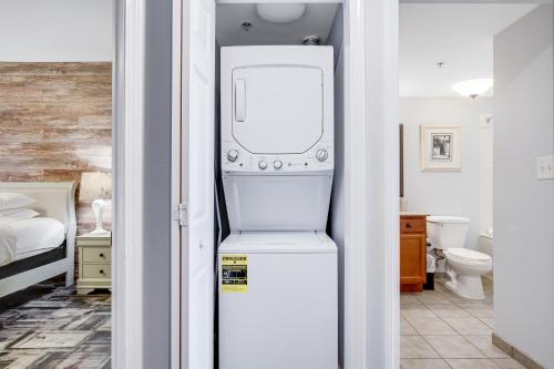 a white refrigerator in a room with a bathroom at Anderson Ocean Club and Spa by Oceana Resorts in Myrtle Beach