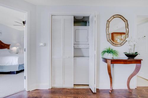 a white room with a mirror and a table at Anderson Ocean Club and Spa by Oceana Resorts in Myrtle Beach