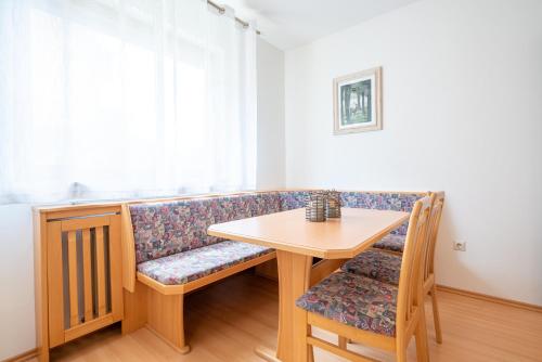 a couch with a table and a table and chairs at Haus Frank & Sophie in Feldkirchen in Kärnten