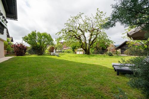 a park with a bench in the grass at Haus Frank & Sophie in Feldkirchen in Kärnten