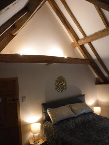 a bedroom with a bed in a room with wooden ceilings at 2 Vicarage Lane in Highworth