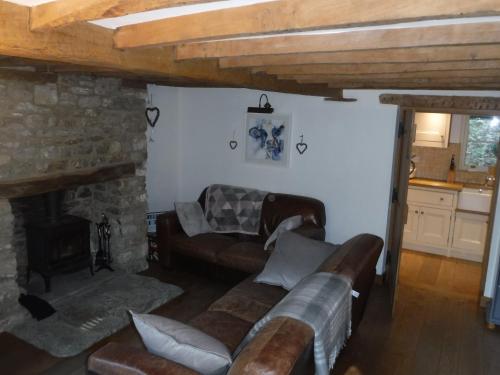 a living room with a couch and a fireplace at 2 Vicarage Lane in Highworth