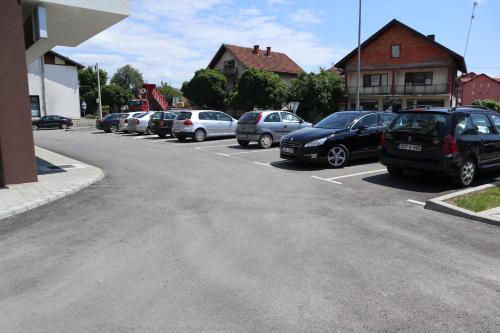 a row of cars parked in a parking lot at Apartman Lilly in Modriča