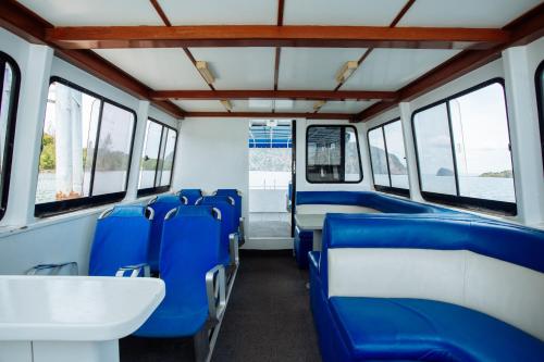 an empty train car with blue seats and windows at Pimalai Resort & Spa in Ko Lanta