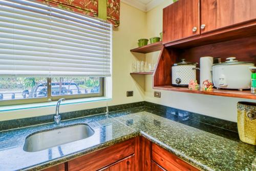 a kitchen with a sink and a window at Torres Colina in Escazu