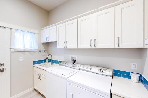 a kitchen with white cabinets and a sink at Seaside Refresh in Seaside