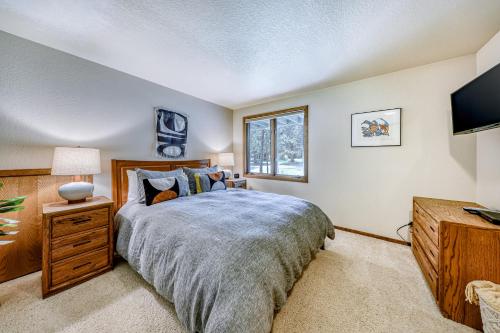 a bedroom with a large bed and a window at 6 Red Cedar in Sunriver