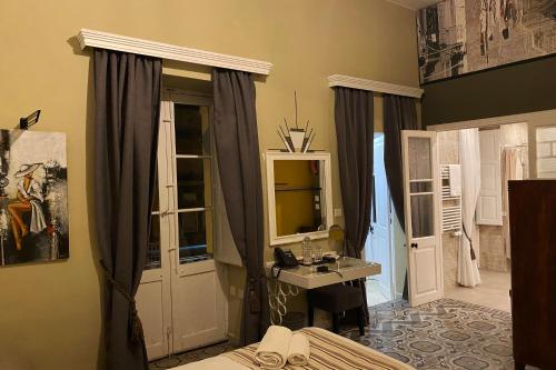 a bathroom with a sink and a mirror at BOCO Boutique Hotel in Cospicua