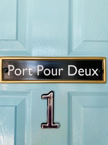 a door with a sign that readsport pour deux at Port Pour Deux in Portrush