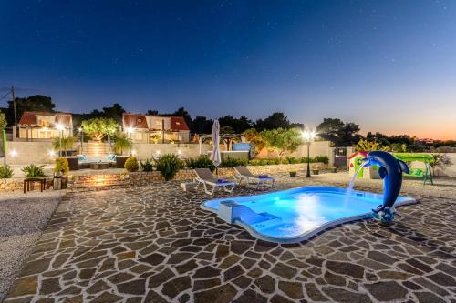 a swimming pool with a swan water slide at Villa Mis in Supetar