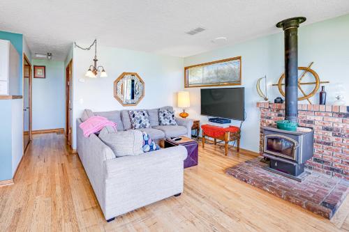 a living room with a couch and a fireplace at Bayocean Retreat in Cape Meares