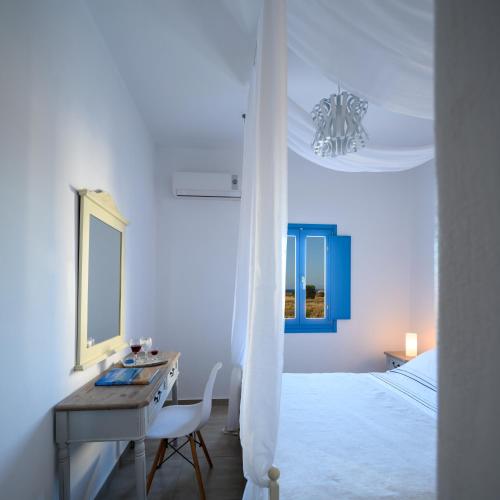 a white bedroom with a desk and a bed at MyBozer Twin Villas Heated Private pools All Year in Foinikiá