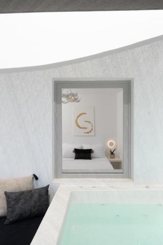 a bedroom with a large mirror on the wall at Canyon Santorini in Fira