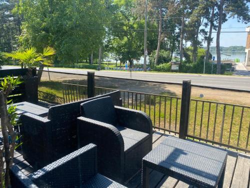 a group of chairs and tables next to a fence at Panzió Tata in Tata