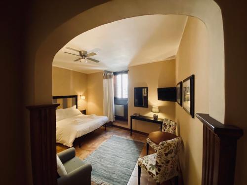 a bedroom with a bed and a ceiling fan at Quo Vadis in Assisi