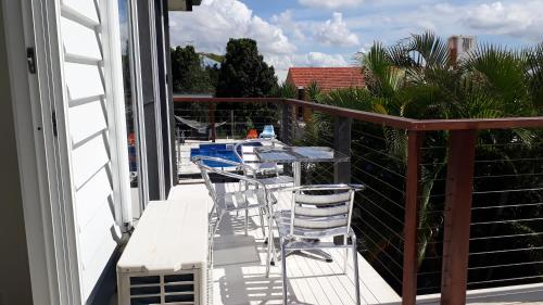 a balcony with a table and chairs on it at Maple Villa - The Beach House by the bay in Brisbane