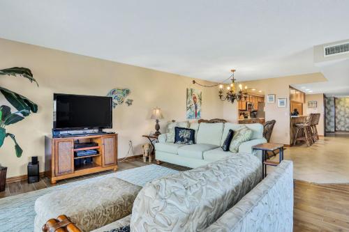 a living room with a couch and a tv at Sand Castle Paradise in Cocoa Beach