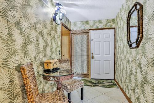 a room with a table and chairs and a door at Sand Castle Paradise in Cocoa Beach