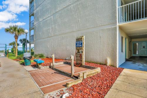 a wooden deck in front of a building at Sand Castle Paradise in Cocoa Beach