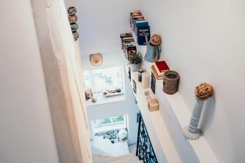a room with a shelf with vases and books at Bascarsija's Sights in Sarajevo