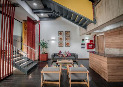 a living room with a couch and a table and chairs at Alko Hotel Integrado in Cali
