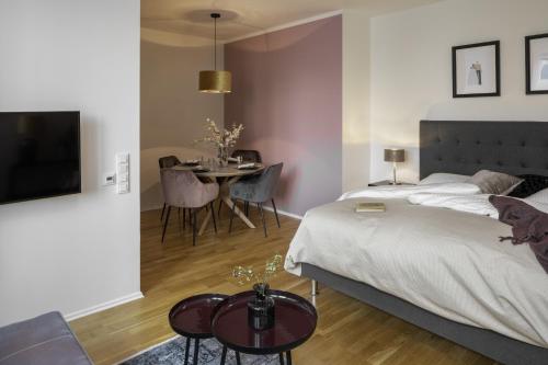 a bedroom with a bed and a table with chairs at Sophisticated Condo in Nusle by Prague Days in Prague