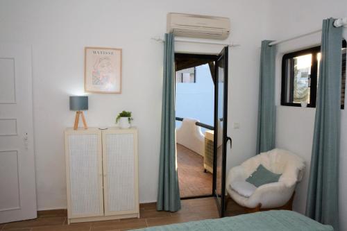 a bedroom with a mirror and a white chair at Shades Of Blue With Ocean View - Fast Wifi in Porches