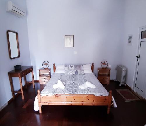 a bedroom with a wooden bed in a room at TRADITIONAL HOUSE ALEPIS IN AREOPOLIS in Areopolis